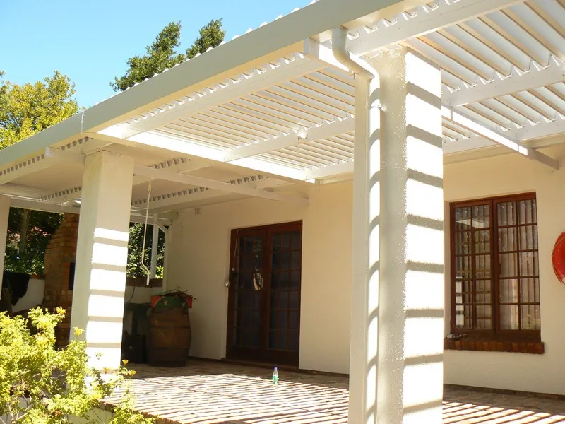 Adjustable louvre awning fitted over a family patio