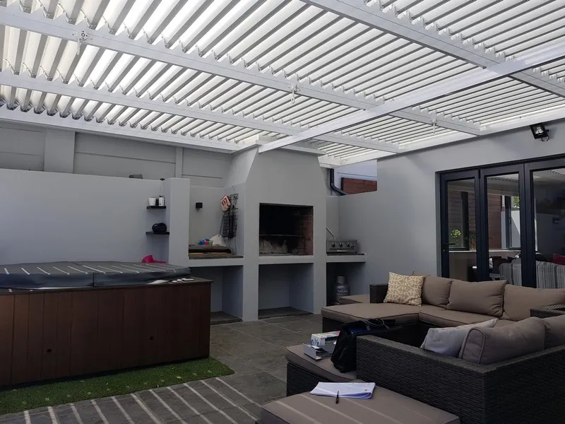 Braced adjustable louvre awning on a mountainside terrace